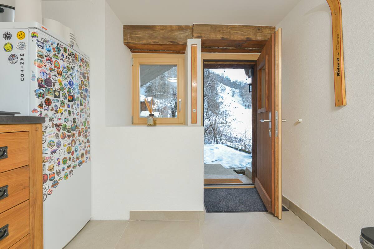 Entrance corner with dresser and the sticker-covered fridge